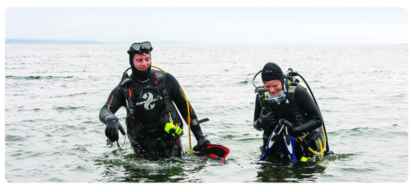 Marine biologists surface from a dive in the ocean